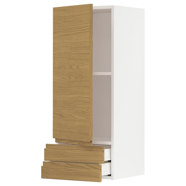 A white and light wood cabinet with open drawers and a door from the METOD kitchen system.