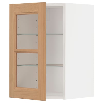 The METOD kitchen cabinet with light oak door and glass shelves. The cabinet has a rectangle shape and minimalist design.