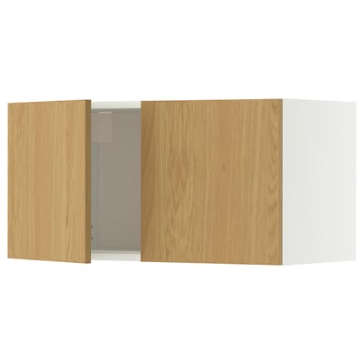 A METOD wall cabinet with light oak doors and a white frame. It a simple, rectangular design with one open door revealing the interior.