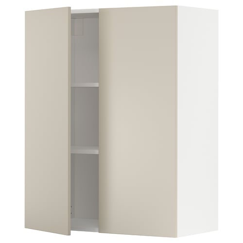 A beige METOD wall cabinet with two doors open, revealing shelves inside. It has a smooth, clean, and harmonious design.
