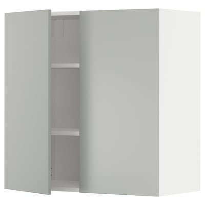 Modern white METOD kitchen cabinet with light grey doors and shelves.