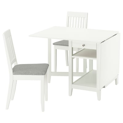 White drop-leaf dining table with storage, two matching chairs with grey cushions, compact and simple design.