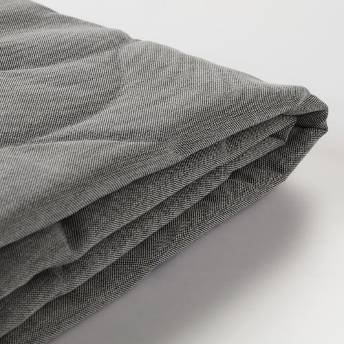 Close-up of NYHAMN sofa cover, showcasing durable, quilted polyester texture.