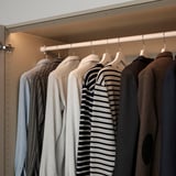 Led closet light automatically illuminates clothes upon door movement.