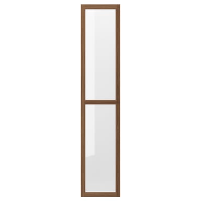 An OXBERG glass door in brown for a bookcase. It a wooden frame and clear glass panels, adding protection and style.