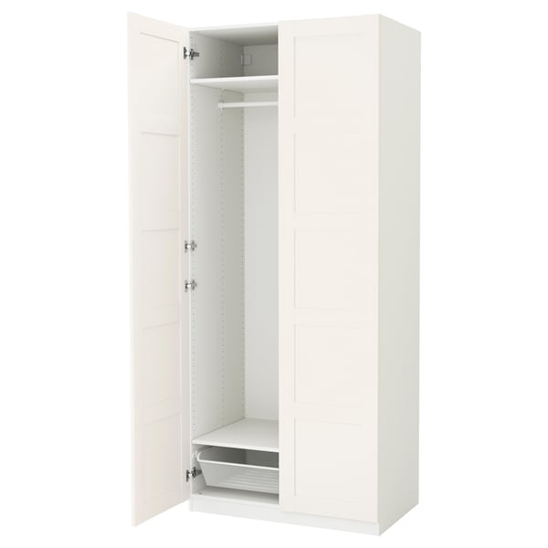 A white PAX wardrobe with one door open, revealing shelves and a mesh basket.