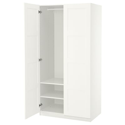 An open white PAX wardrobe with shelves inside. The design is minimalist and modern.