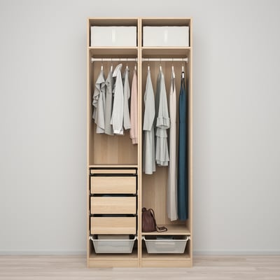 A wooden wardrobe with hanging clothes, drawers, and baskets, designed for maximising storage space.