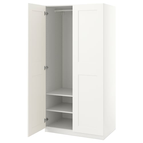 White PAX wardrobe with open doors, showing metal hang rail and shelves.