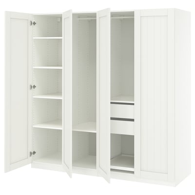 White PAX wardrobe with open doors revealing shelves and compartments, wooden structure.