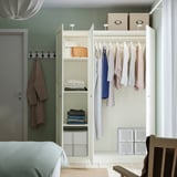 Mirored wardrobe with clothes, shelves, & hooks.