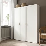 White wardrobe unit with two woven baskets on top. Protection from dust. Clean, simple design.