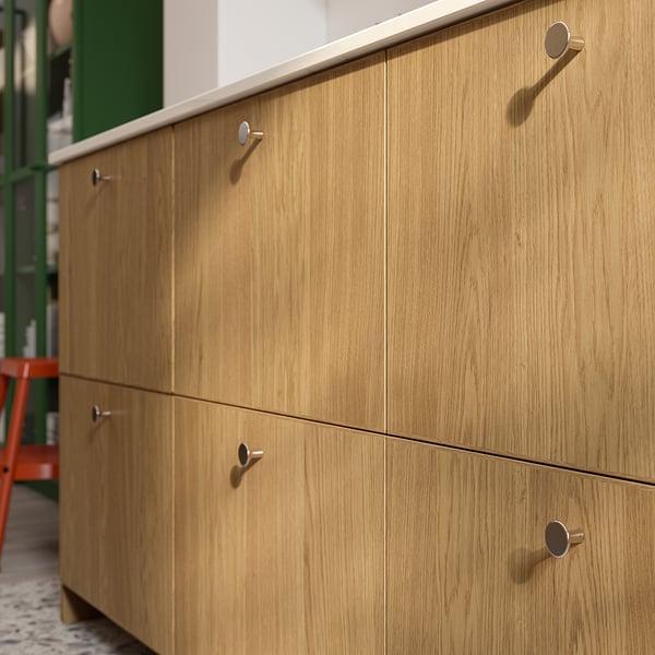 Wooden cabinet with multiple drawers, handles, and oak finish.