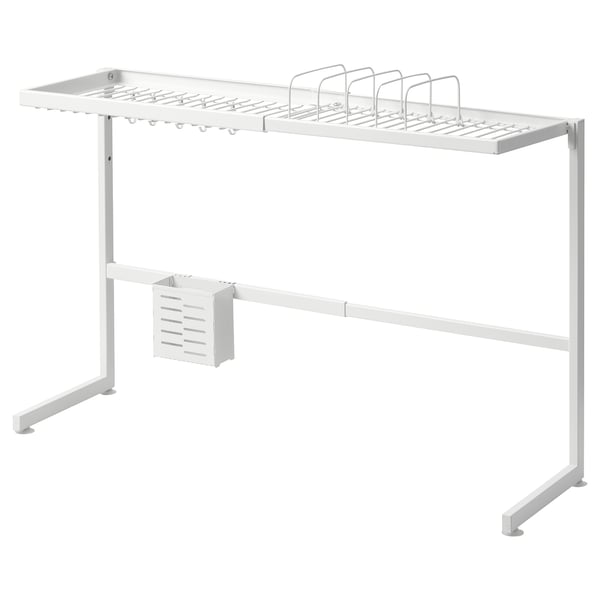 A white SKYGGFISK dish rack with multiple compartments, hooks, and a cutlery section. It sits over sinks, draining dishes efficiently.