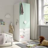 Kids room with green SMÅSTAD wardrobe, soft-closing doors, three drawers, and teddy bear by window.