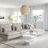Modern living room with light grey SÖDERHAMN sofa, large cushions, white coffee table, and unique pendant lamp.