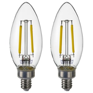 Two clear SOLHETTA bulbs with yellow coiled filaments, round glass shape, silver base.