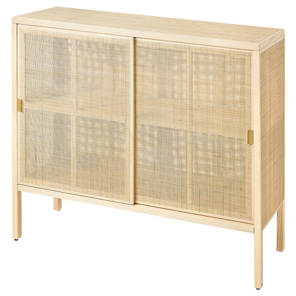 A STOCKHOLM 2025 beige cabinet with sliding doors made of natural rattan and solid pine, featuring elegant brass handles and a sleek design.