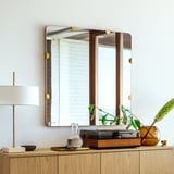 STOCKHOLM 2025 mirror: square, oak frame, brass fittings. Large, hangs above console with lamp, vase, and decor.