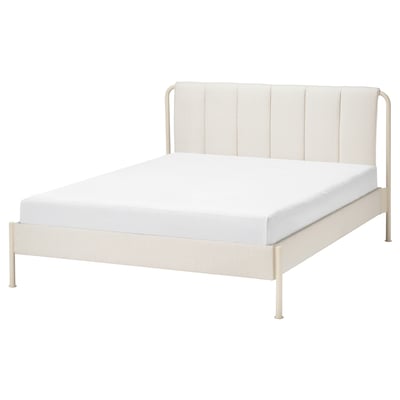 Minimalist white bed with metal frame and padded headboard.