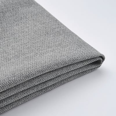 A folded light grey textured fabric, possibly upholstery or bed cover, displayed against a plain light background.