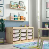 Kids playroom with TROFAST light wood storage. Colourful boxes, wooden shelves, and childs artwork.