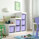 TROFAST storage with purple boxes in kids room. White frame holds six boxes, kid-friendly. Green dinosaur toy nearby.