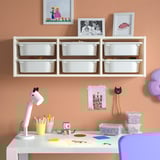 Childrens storage system with toys, desk, lamp, chair, and craft supplies.