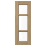 A VEDHAMN oak cabinet door with three glass panels, sleek and rustic.