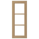 A VEDHAMN kitchen cabinet door in natural oak wood with glass panels framed by solid oak.