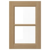 This image shows a VEDHAMN wooden kitchen cabinet door in natural oak with a clear glass panel.