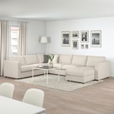 Modern living room with large beige VIMLE sectional sofa, black & white photos, and wood floor.