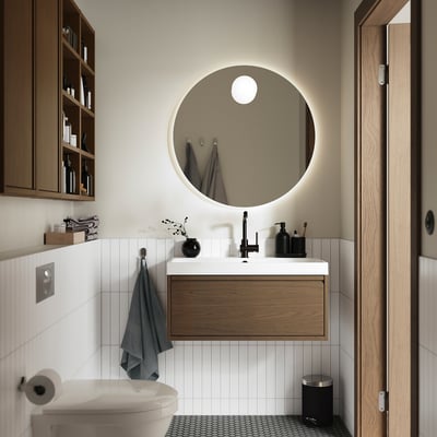 Modern bathroom with oak vanity, white basin, and minimalist design. White tiles, round mirror, and blue towel.