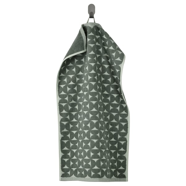 A hanging grey-green ÄNGSNEJLIKA towel with a jacquard geometric design.