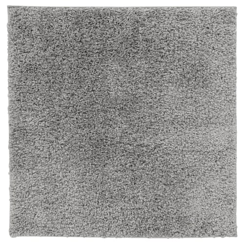 A square grey ÄRENDE rug with a shaggy texture, made of polypropylene and synthetic rubber, ideal for comfort and sound absorption.