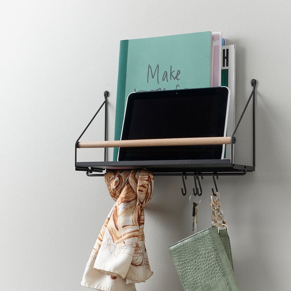 Wall-mounted organiser with shelf, holding laptop, books, and handbag, plus hooks for accessories.