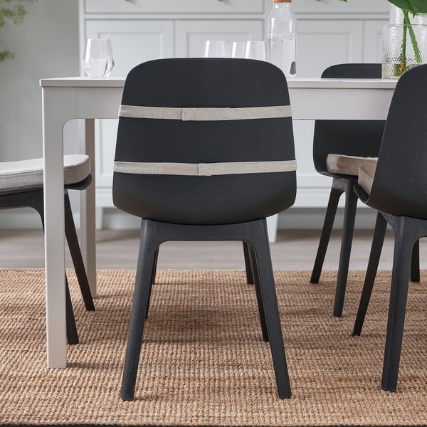 Modernization, comfort in focus: black chairs with beige lumbar cushion, adjustable straps, and foam support for cosy seating.