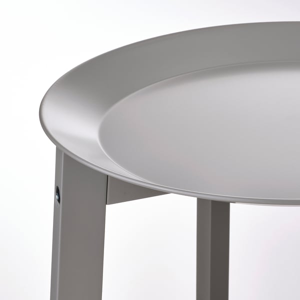 Modern, round plant stand with a sleek, white, circular tray. Solid, wooden legs securely support the tray.
