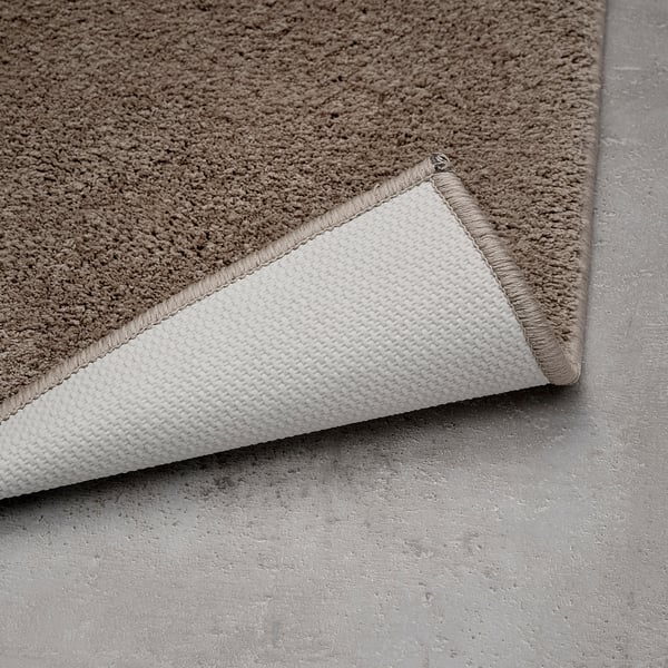 BACKMÅRA Bath mat, beige round, 55 cm