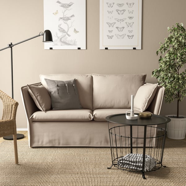 BACKSÄLEN 2-seat sofa in neutral living room with coffee table & wall art.
