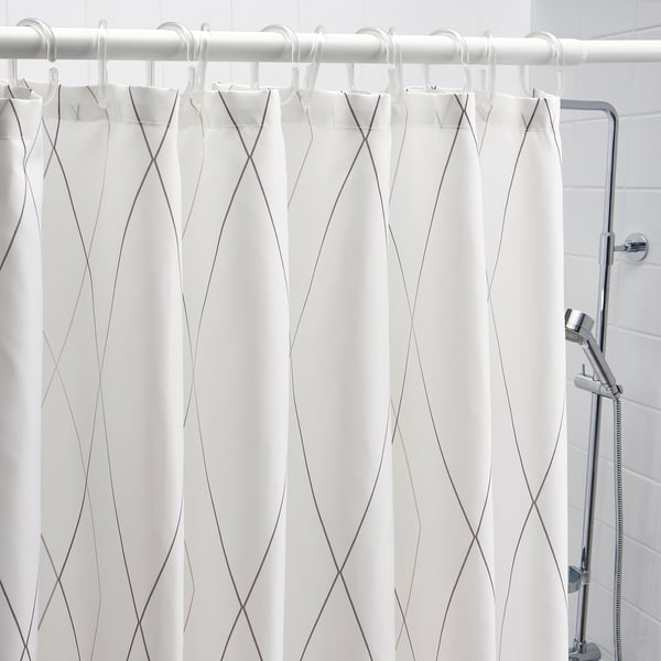 White shower curtain with grey abstract lines hangs neatly, featuring a water-repellent surface for bathroom use.