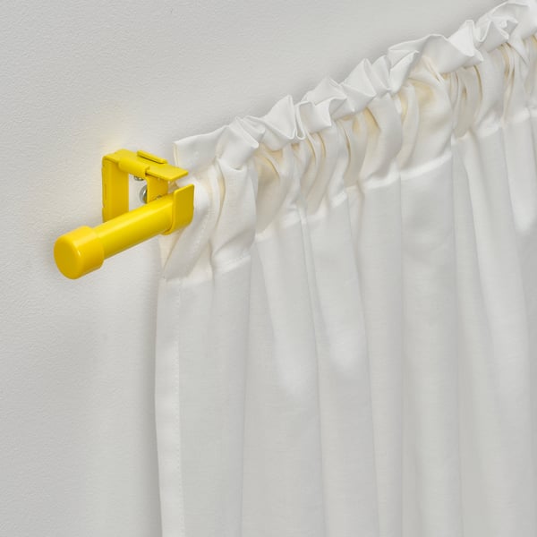 Bright yellow curtain rod set with white curtains, mounted on wall. Includes connectors for extending rods.