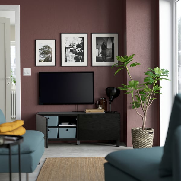 Modern living room with flat-screen tv and dark wooden stand with adjustable shelves and cable management, black and white wall art.
