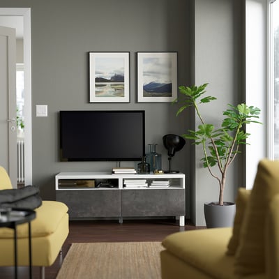 Modern living room with BESTÅ tv stand, plant, and yellow chair.
