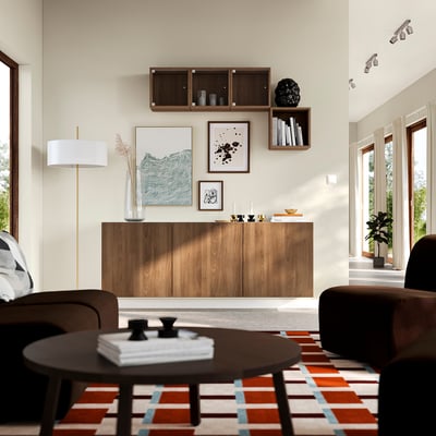 Modern living room with BESTÅ storage, lamp, rug, chairs, and coffee table.