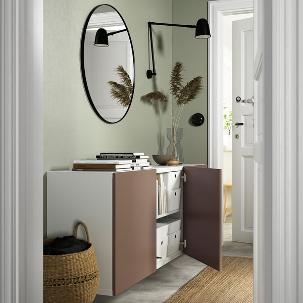 Modern wall-mounted cabinet with doors open, revealing organised storage. Adjustable shelves and minimalist design.