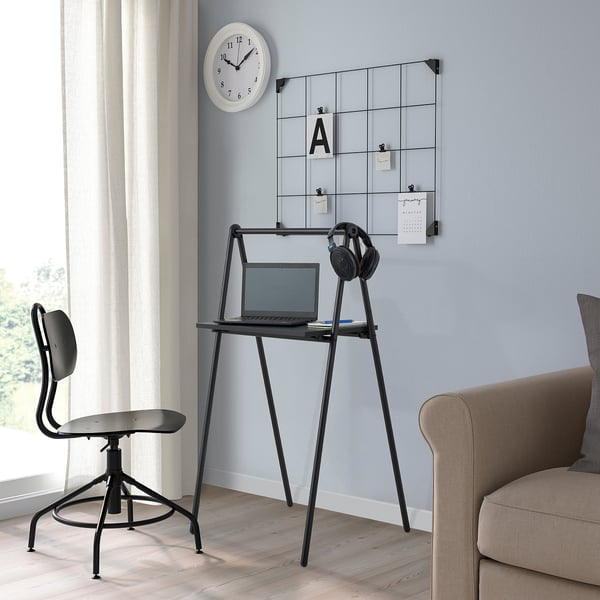 BJÖRKÅSEN fold desk beside sofa with laptop, headphones, clock, and mirror.