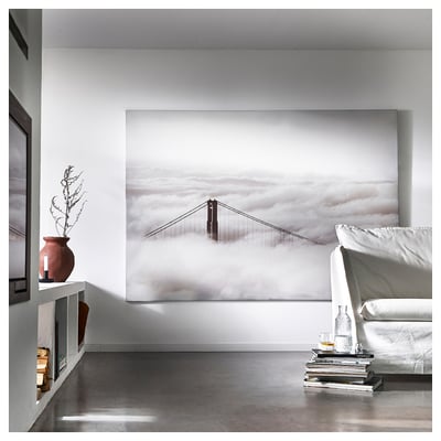 Minimalist living room with large framed bridge artwork and sleek furniture.