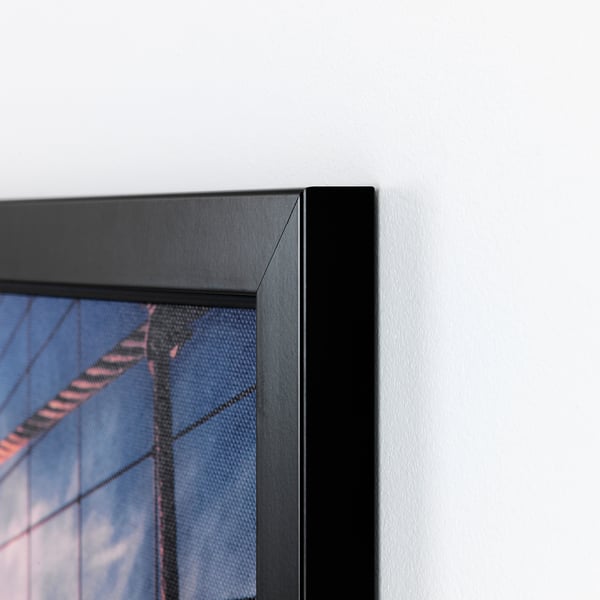 Close-up of high-quality bjorksta framed picture, sleek black frame showcasing a vibrant image, corner detail visible.