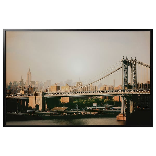 Framed photograph of manhattan bridge and nyc skyline in sepia tones.